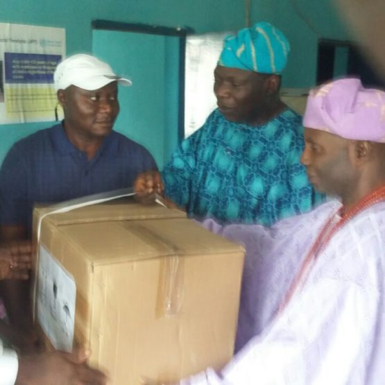 Dr David Kolawole Aina on behalf of Igogo Health Professionals donating a portable ultrasound scan machine to Comprehensive Health Centre, Igogo Ekiti